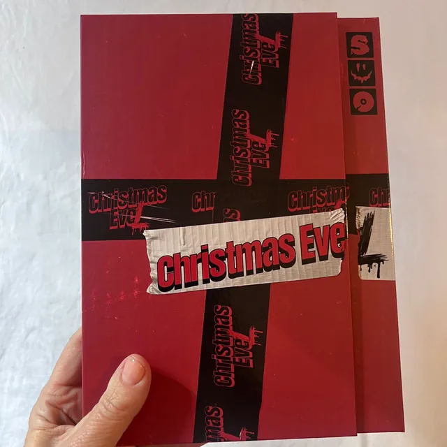 The Stray Kids Christmas EveL album in its red case, held in one hand